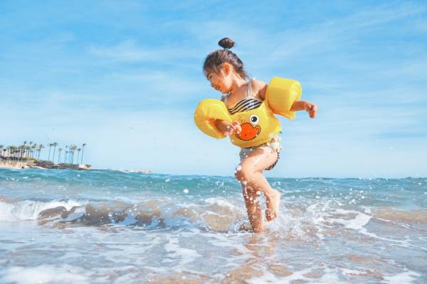 Child playing on the beach during vacation
